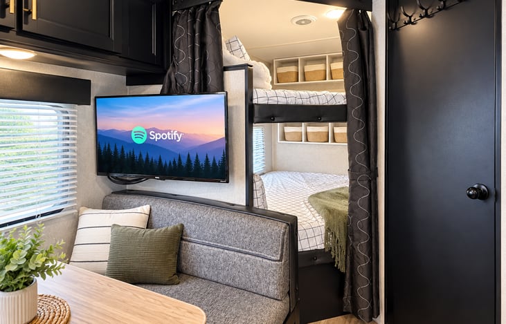 Bunks with storage, Roku TV and kitchen table.