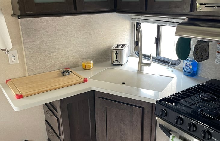 plenty of work area at kitchen sink. Kitchen has little extras like over sized toaster for waffles and Keurig coffee maker for convenience.