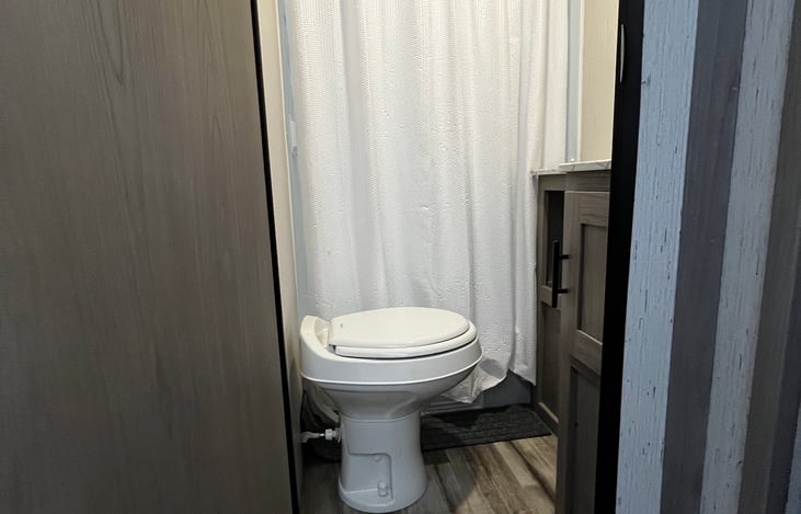 Bathroom, stand up shower, sink and storage