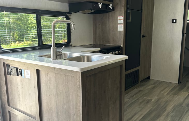 Kitchen Includes Large Camper Size Fridge and Freezer, Microwave, and Pantry, and all you need to cook and eat with.