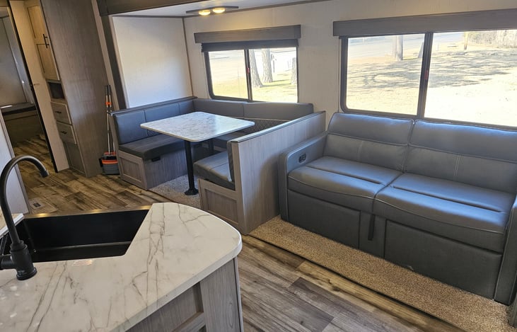 Kitchen/dining and living space;
Jack knife sofa and convertible dinette.