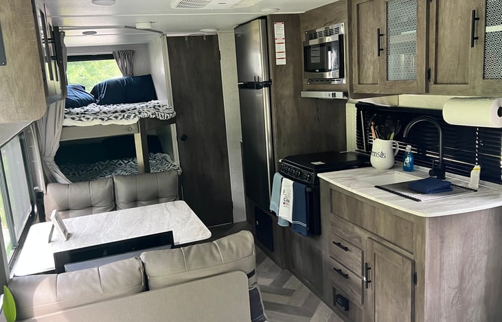 Fully equipped kitchen. Not pictured Enjoy coffee in the morning with the coffee pot or meals with the included air fryer. Dinette converts to a sleeping spot if needed.