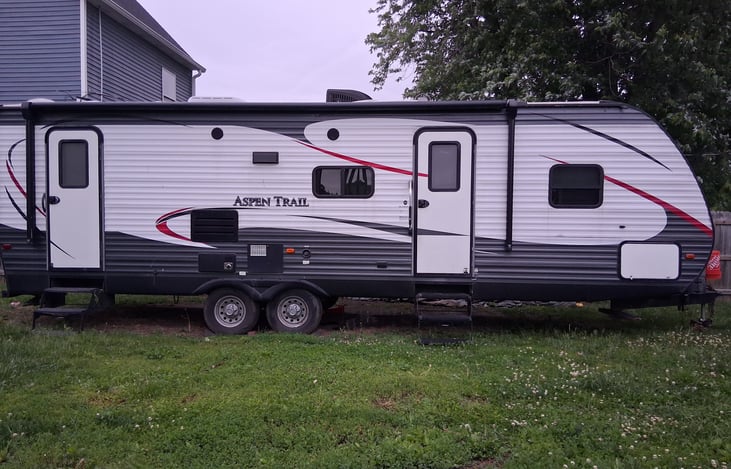 Right side of the trailer (where awning is). Has 2 doors for the bathroom and main entrance. Also has keyless locks (keypad with code)