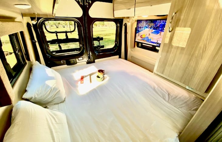 Rear RV King fold out bed is super comfortable. Comes with mattress topper, pillows, and all linens. Swing away TV is connected to an antenna booster.