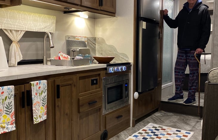 Apartment-sized refrigerator freezer.  The shower stall is 6'3 inches tall with a skylight.
