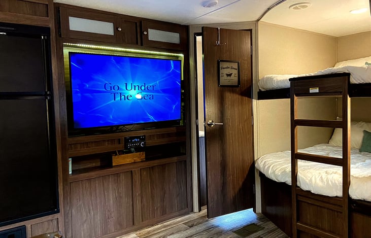 50" I think. The stereo also plays DVDs on the TV. It swivels a bit so the kids in the bunks can watch, as long as the bathroom door isn't wide open.