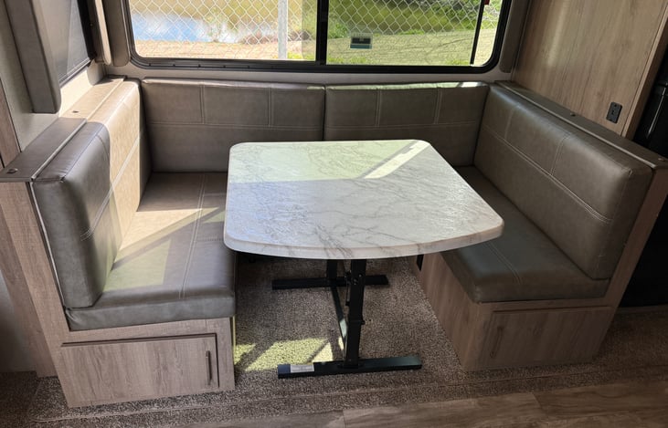 This booth style dining area easily converts to a large bed, measuring 77" long by 45" wide.  It is a very comfortable and can accommodate adults as well as children.  This table can also be moved.