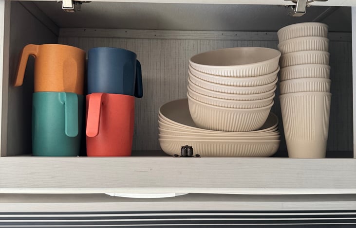 Mugs, cups, bowls, and plates are included.