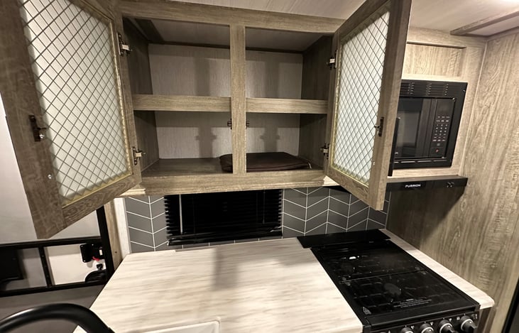 cupboard over cooking area for kitchen utensils