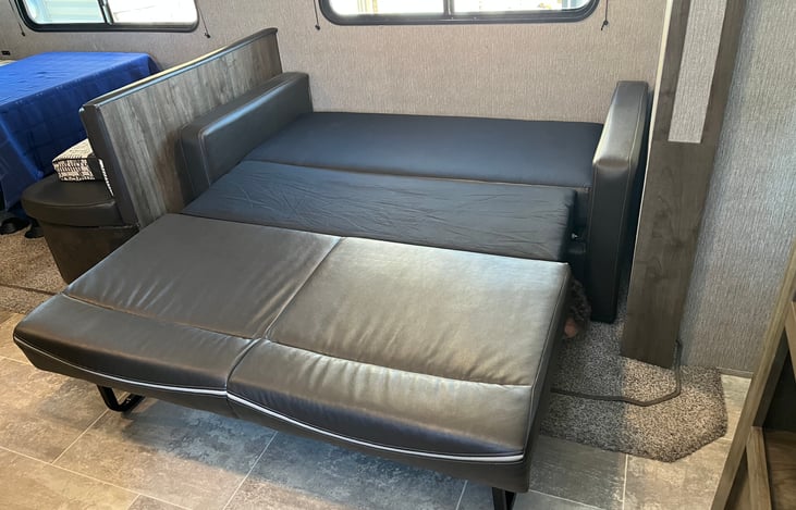 Fold out couch with thick pads. This is a comfortable bed for adults.