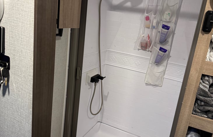 Spacious RV shower with skylight above for extra headroom and natural light.