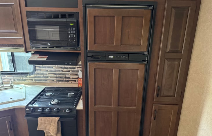 Kitchen, gas stove, microwave, pantry (floor to ceiling on right)