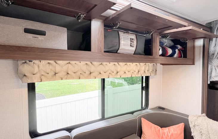 Bedding for dinette is stored above along with a couple indoor/outdoor blankets and games.