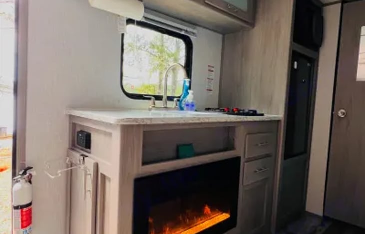 View of the kitchen and the fireplace. Gives it a cozy feel and the heater will definitely keep you warm.