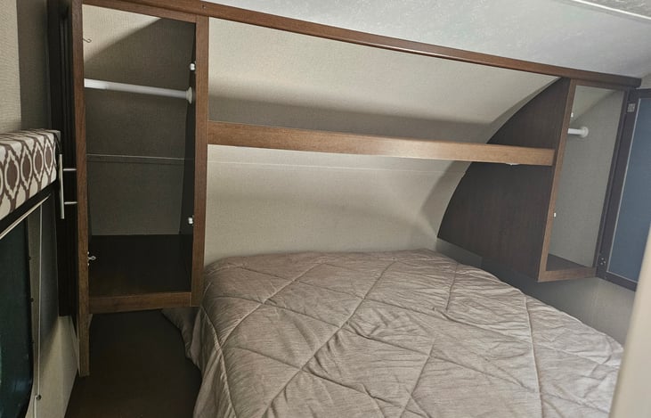 Front queen bed with storage above and on each side