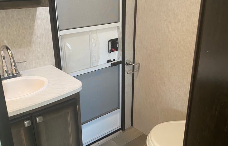 Bathroom sink and toilet with its own door to the outside