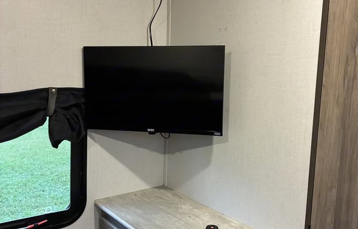 Guests or kids can have their own space in this private bunk house with couch and a tv.