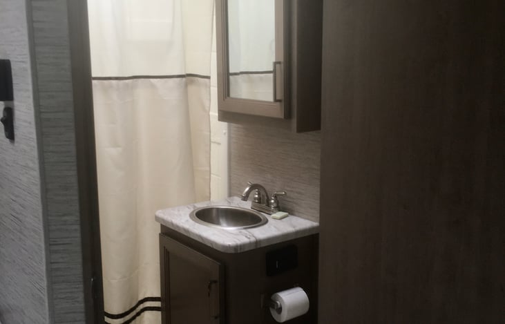 Full sink and medicine cabinet for personal items