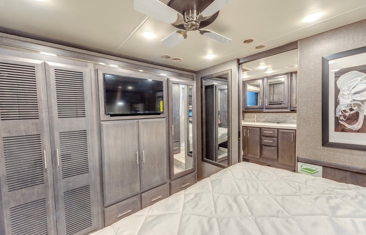 Master bedroom with kingsize adjustable bed, ceiling fan, washer dryer, television, master bathroom
with couples sinks and vanity and oversize shower.