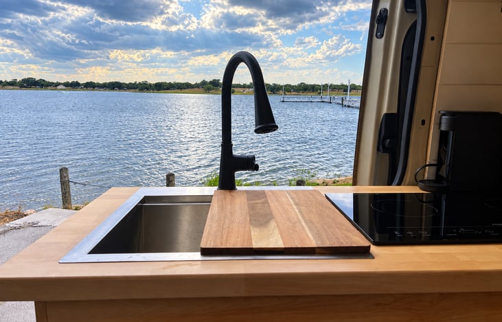 Doing dishes isn’t so bad with a view like this! Enjoy a full-size sink, beautiful butcher-block counter and a kitchen designed for life on the road.