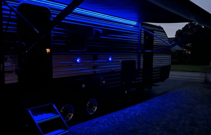 Front porch sittin’ with an electric awning and blue lights for the night.