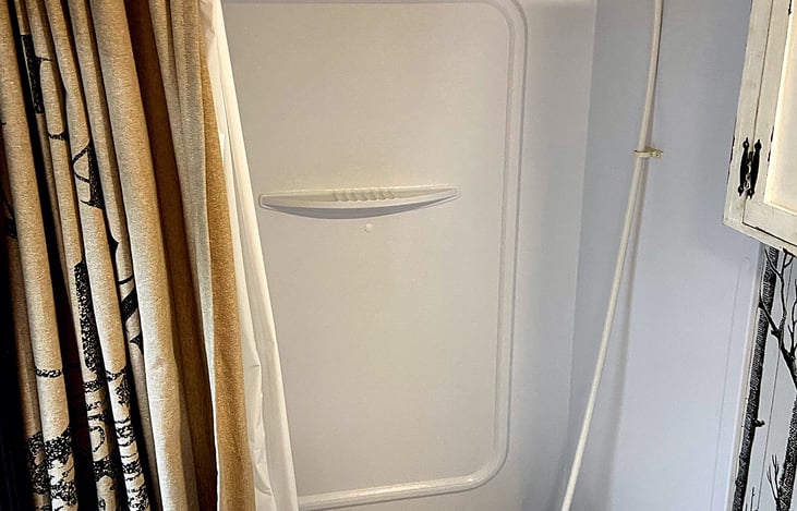 Not just a shower, but also a tiny little tub for bathing the little kiddos or filling full of ice and White Claws, I mean you do you.