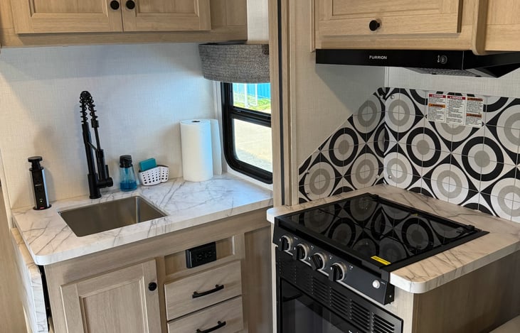 Kitchen area with sink, stove and microwave