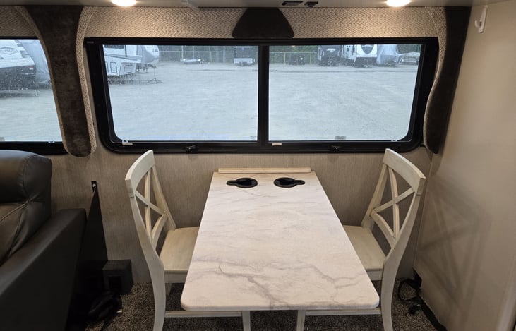 View of dining area for two or more seating. OR move tables and lower table for an additional sleeping area.