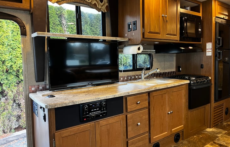 Auto TV rises from the counter for indoor entertainment.