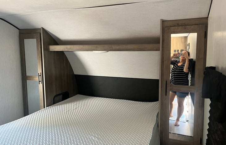 Queen bed with memory foam topper for comfort. Closets on each side with rack for hangers, and additional trunk storage space under the bed. USB  chargers on each side and bedside lights.