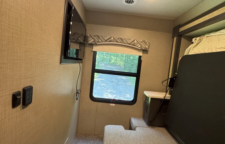 Bedroom with bed folded up  but you can see one of the three TV's   We even have an outdoor TV