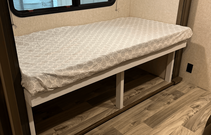 Bunk room couch taken out and converted into twin size bed - can be accommodated with child folding safety rail