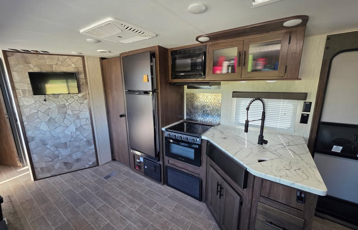 TV is in an ideal space for viewing from the table, couch, and loft.  TV plays DVD's only.