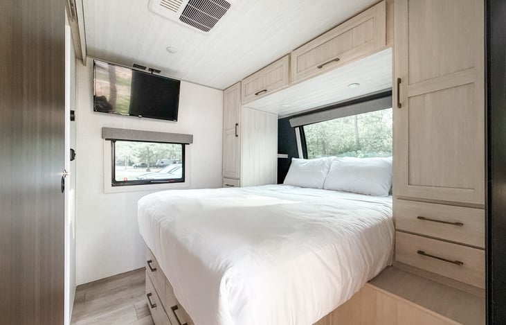 Primary bedroom with movable Roku TV.