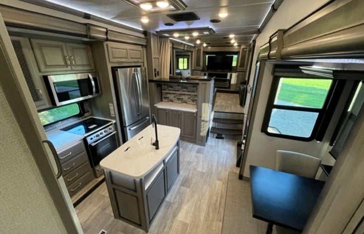 Kitchen area with table in 2 person dining configuration.