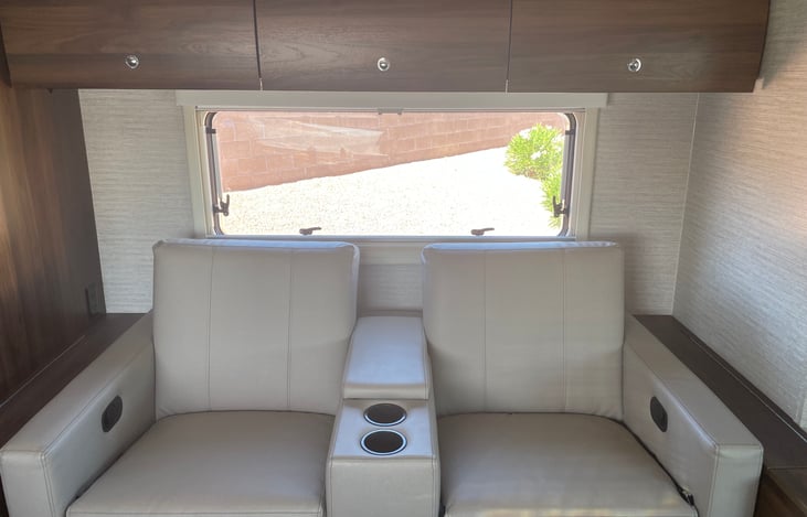 24D without dinette has 2 comfortable theater seats with hideaway trays.