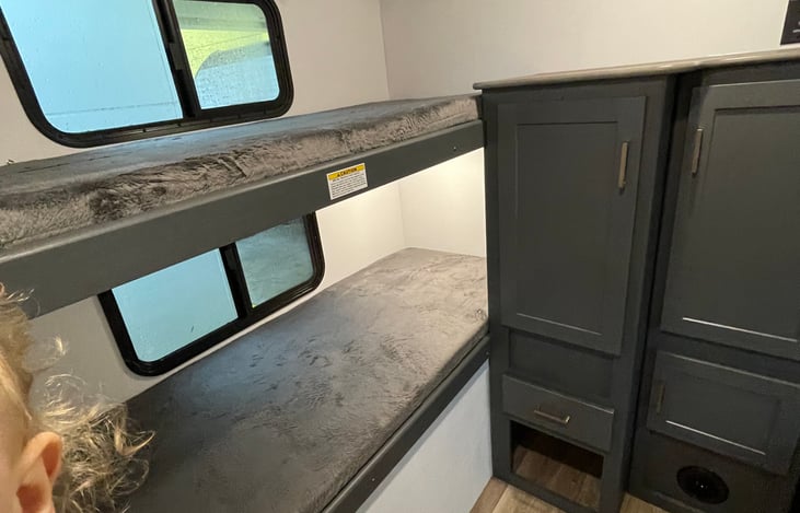 Bunk room- sleeps 4. Bottom bunk features toddler rail for safety, if needed. TV hookup available for use. This is back of RV.