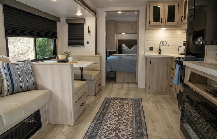 4 seater dinette, pull out sofa, entertainment center with fireplace and smart TV, and fully equipped kitchen.