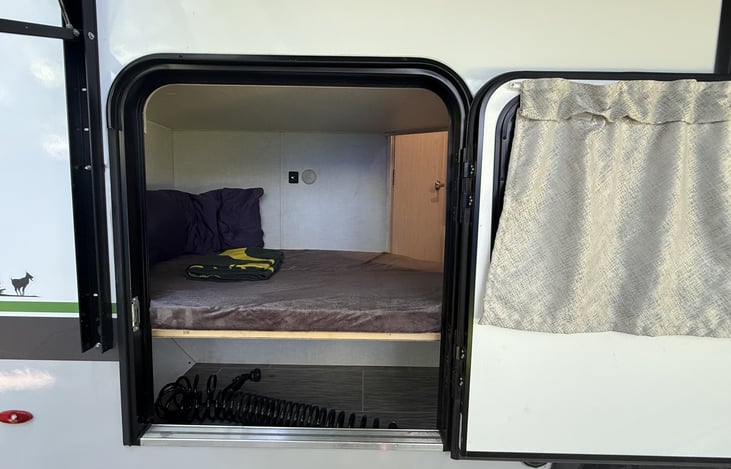Rear lower bunk bed exterior entry and lower storage.