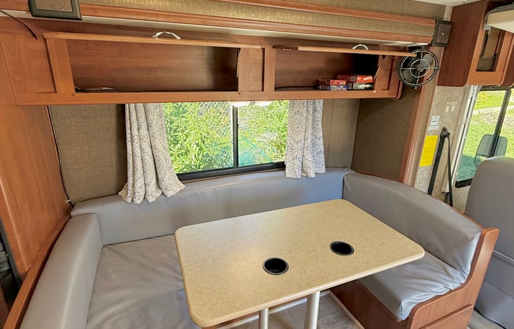 Dinette/convertible bed area. Overhead storage with games.