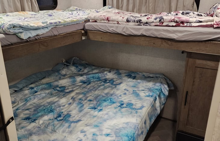Large queen bed that folds back to a bench and 2 fold down bunks.