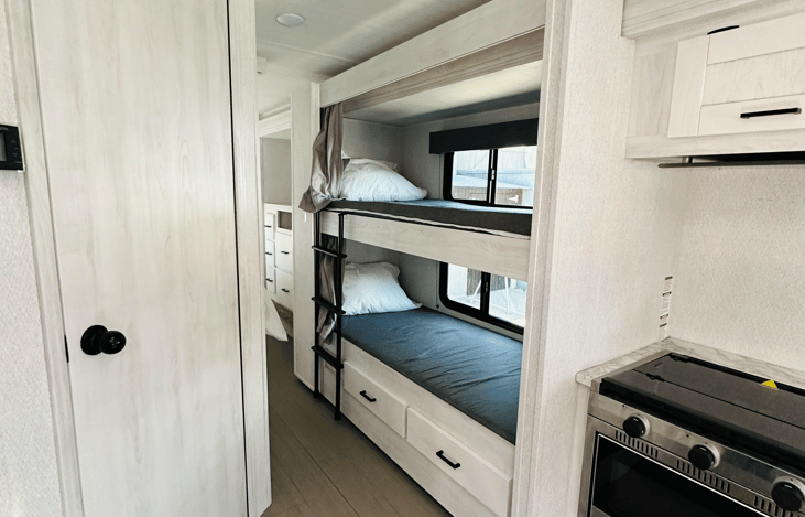 Bunk beds that have their own outlet and window (which is really rare!) Also both have a privacy curtain.