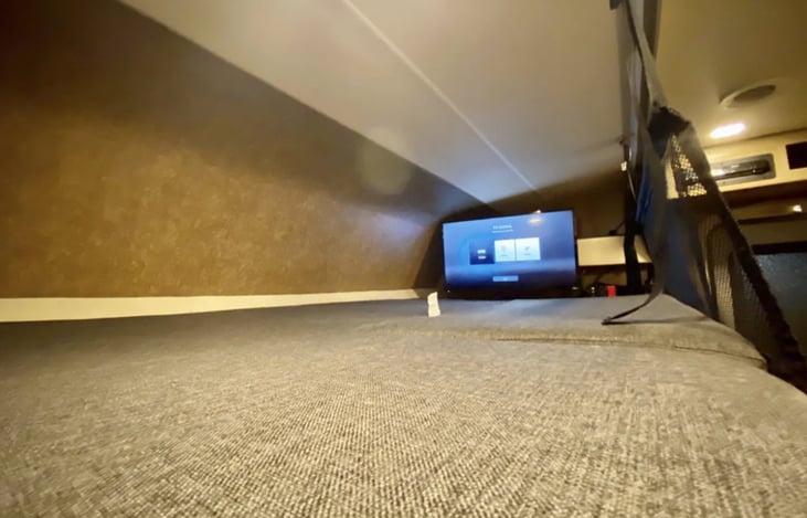 Overhead sleeping area. TV swings out for viewing from living area