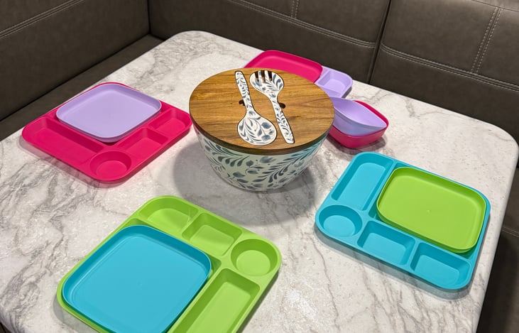 Our trailer includes everything you see in the pictures. Here are place settings for kids and a Salad Bowl. Not shown are adult place settings, silverware for six and a full utensil drawer.