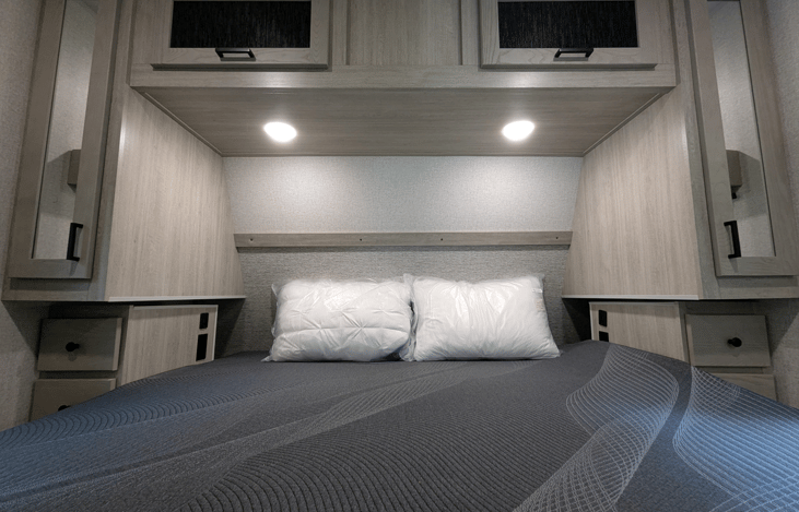 Nice bedroom with comfy King size bed, ample storage cubbies and windows for natural sunlight.