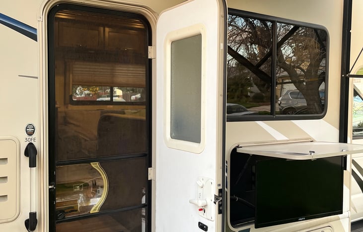 Side entry with screen door. Outdoor TV allows for more time outdoors to enjoy your day.