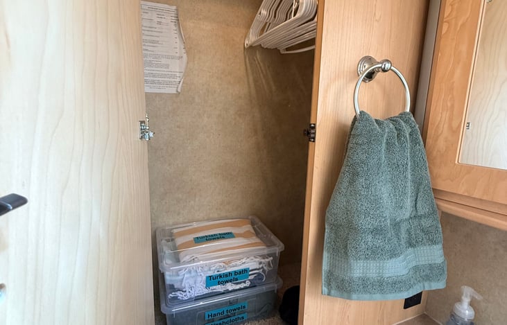 Closet stocked with fresh towels and hangers—ready to keep your gear organized on the road 👕🧺