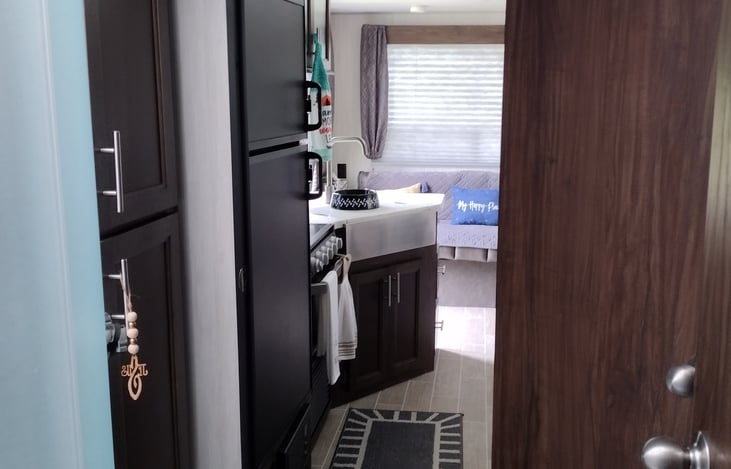 Plenty of room in the bathroom to move about. Storage also located in bathroom.