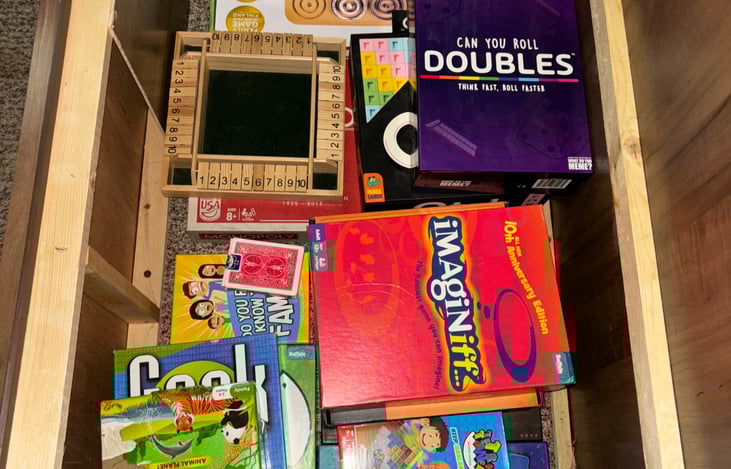 Games in dinette storage (under bench on right)