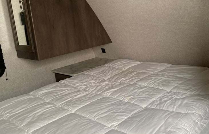 Queen sized bed with nightstands and USB ports to charge phones.